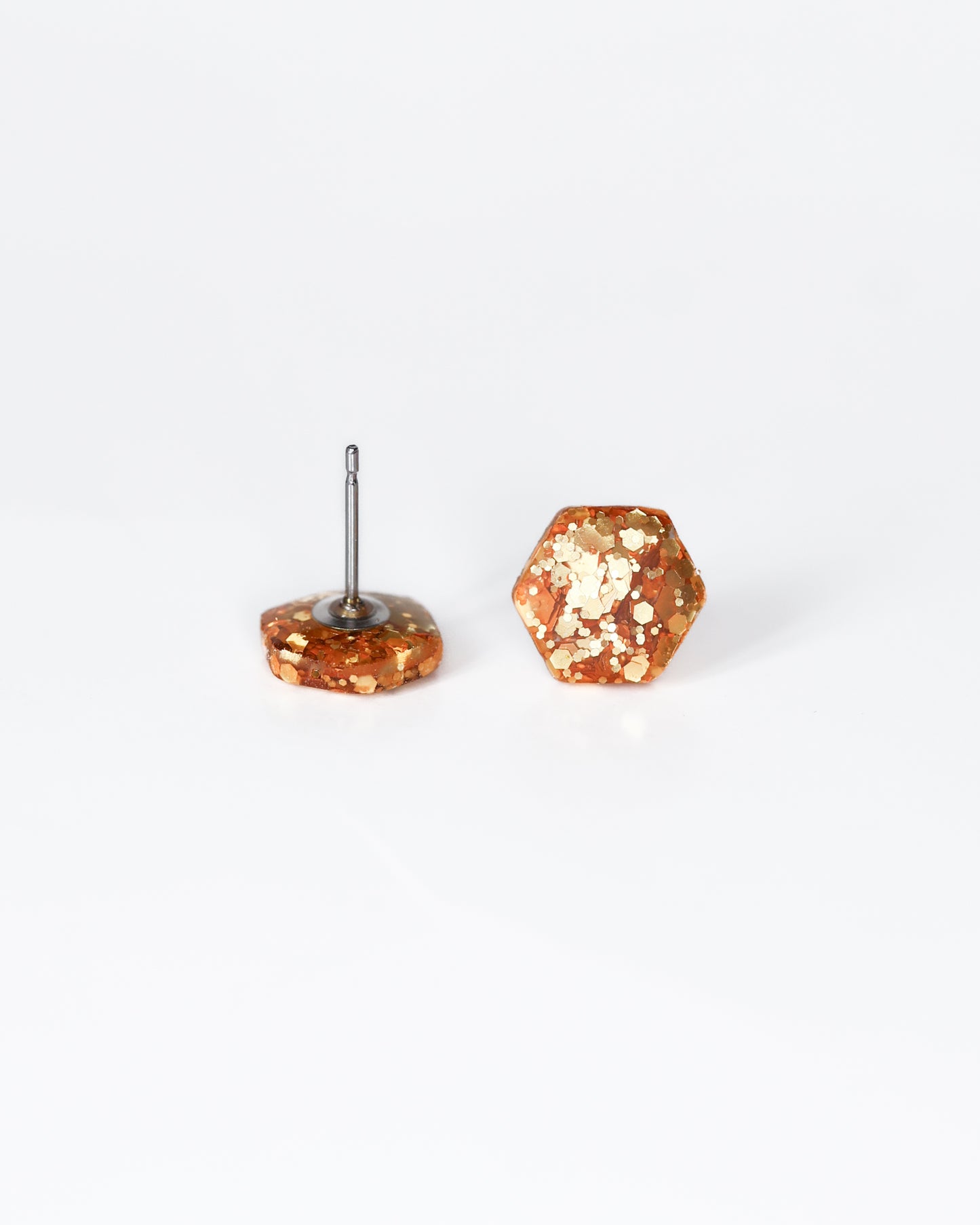 Delicate golden hexagon stud earrings with surgical hypoallergenic posts
