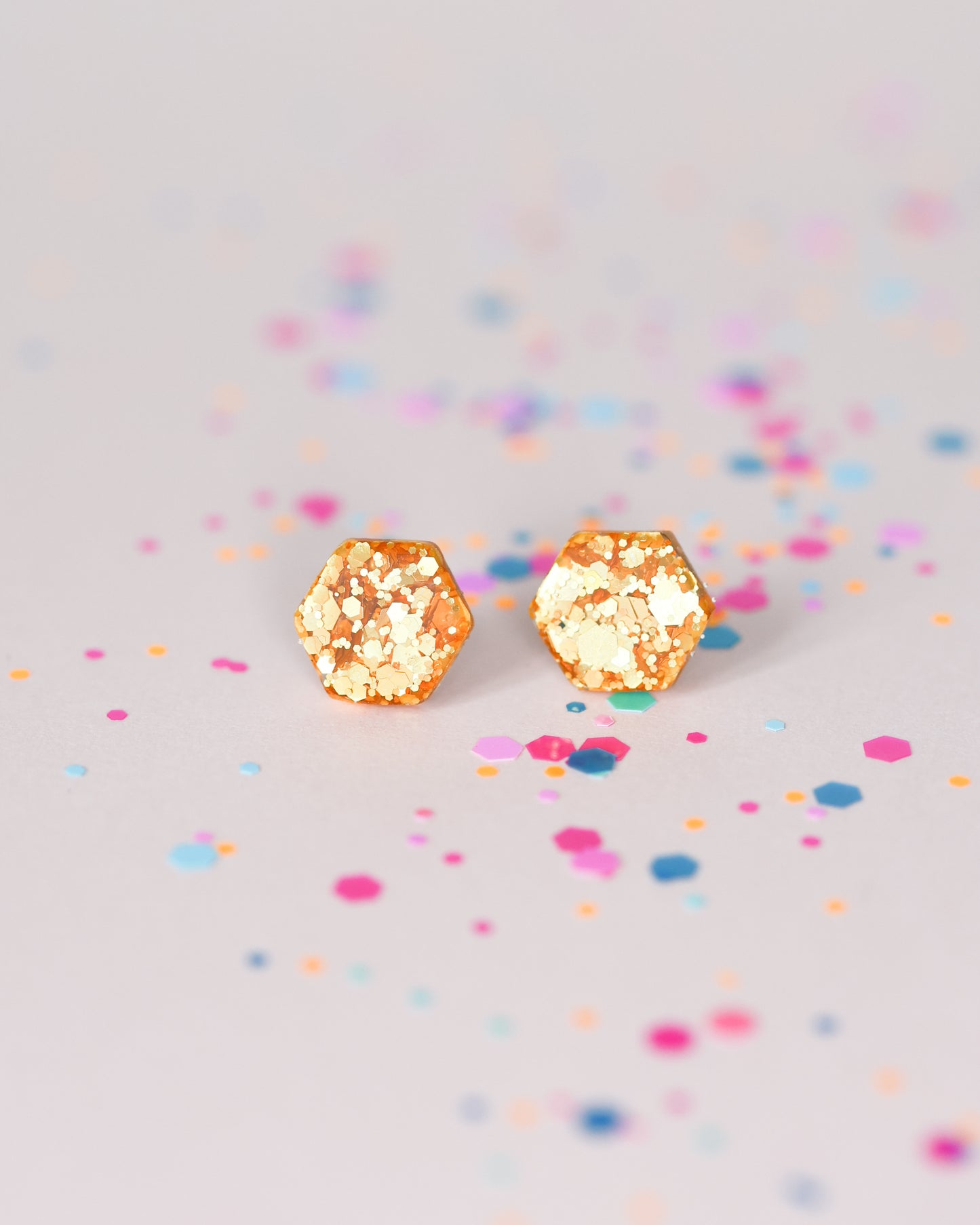 Delicate golden hexagon stud earrings with surgical hypoallergenic posts