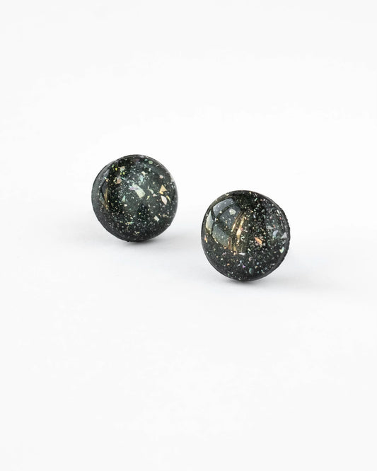 Pair of black stud earrings with gold specks on a white background
