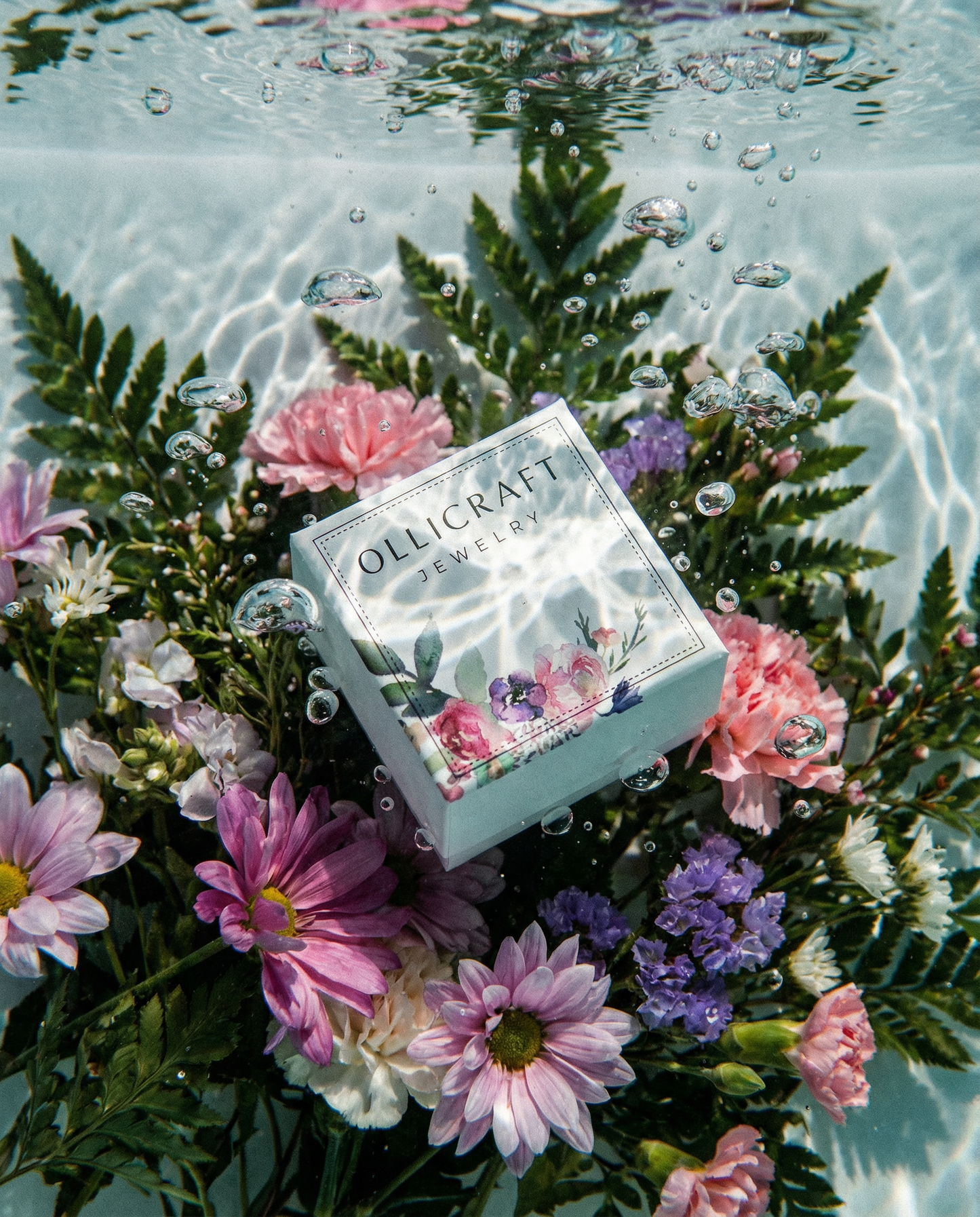 Ollijewelry jewelry box surrounded by water and flowers