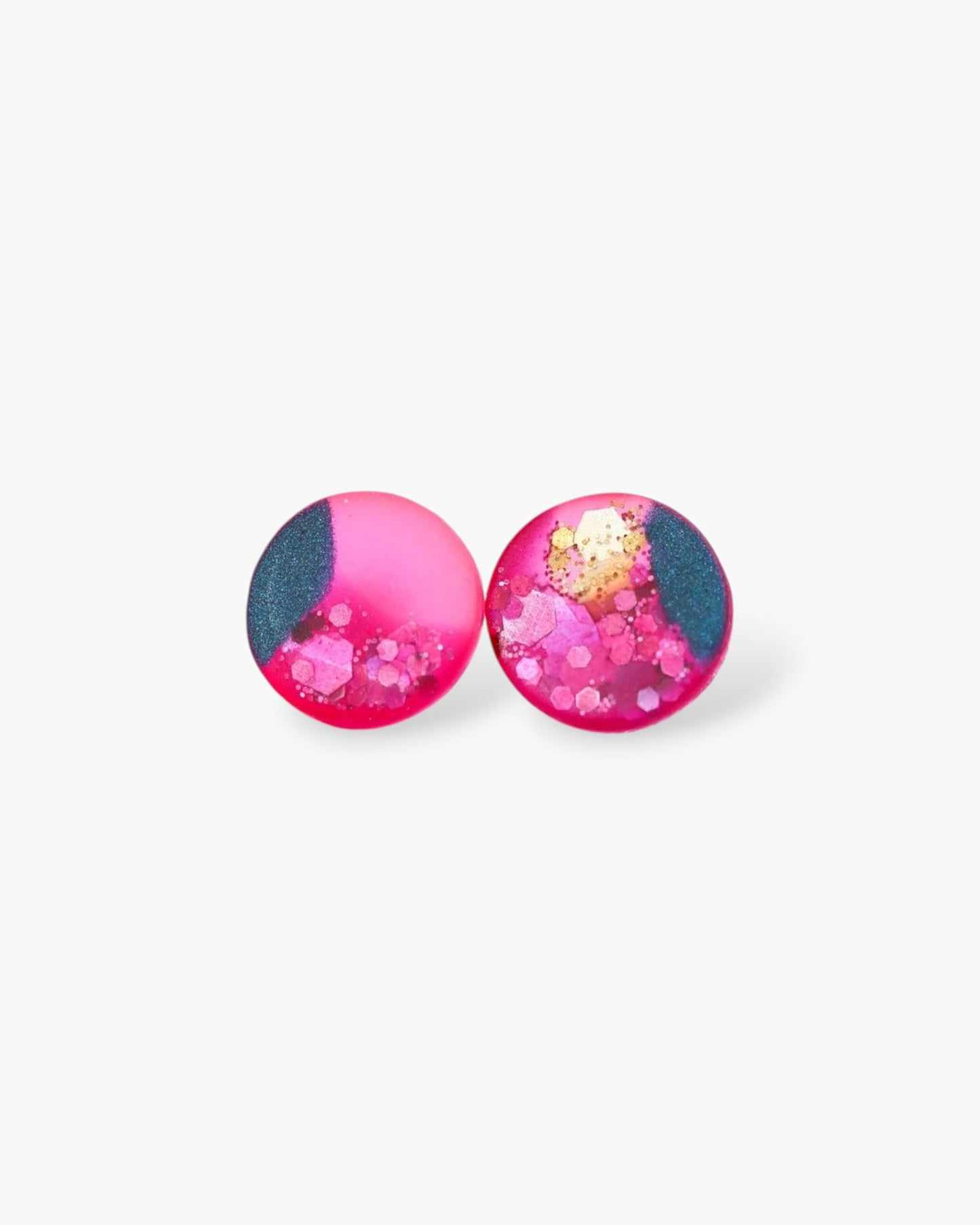 Pair of round earrings with pink and blue design on a white background