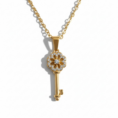 Gold key pendant necklace with crystal accents on a delicate chain, minimalist jewelry