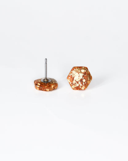 Delicate golden hexagon stud earrings with surgical hypoallergenic posts