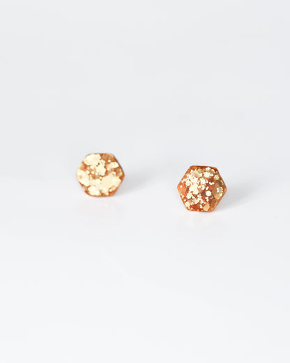 Delicate golden hexagon stud earrings with surgical hypoallergenic posts