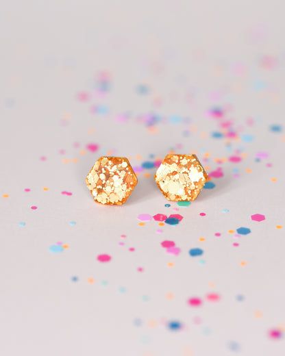 Delicate golden hexagon stud earrings with surgical hypoallergenic posts