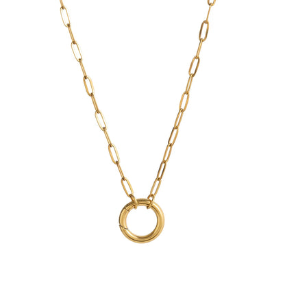 Minimalist gold chain necklace with round pendant on white background