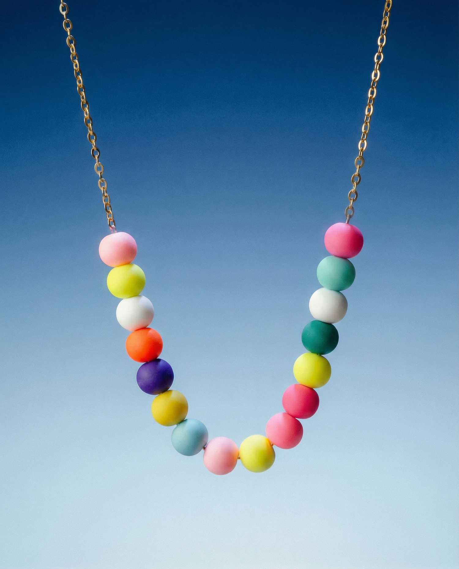 Necklace with colorful beads on a blue gradient background