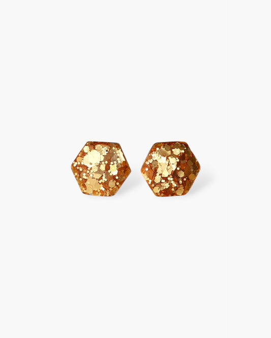 Delicate golden hexagon stud earrings with surgical hypoallergenic posts