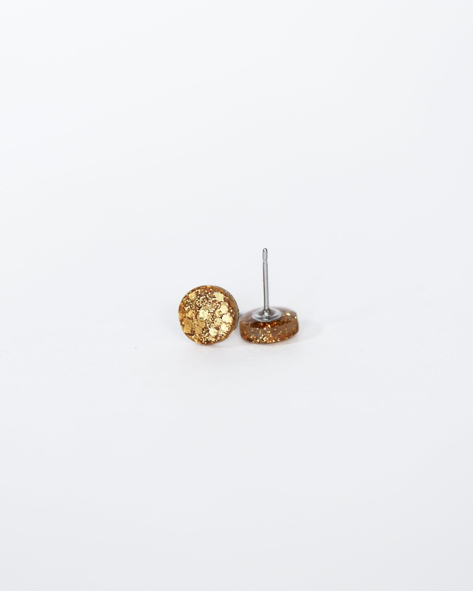 Gold textured sphere earrings on a white background