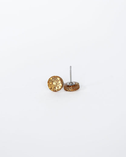 Gold textured sphere earrings on a white background