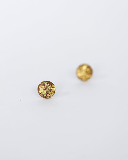 Two gold round beads on a white background