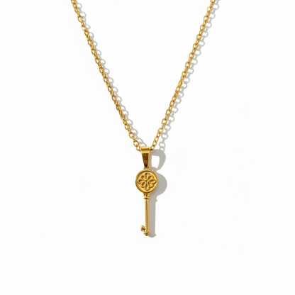 Gold key pendant necklace with flower detail on a minimalist chain, handmade jewelry