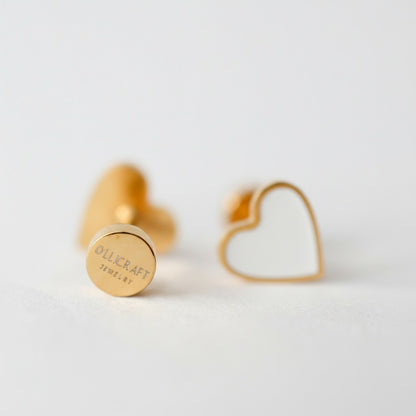 Minimalist gold and white heart-shaped stud earrings on white background