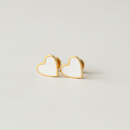 Minimalist gold heart stud earrings with white enamel, flat back, on neutral background
