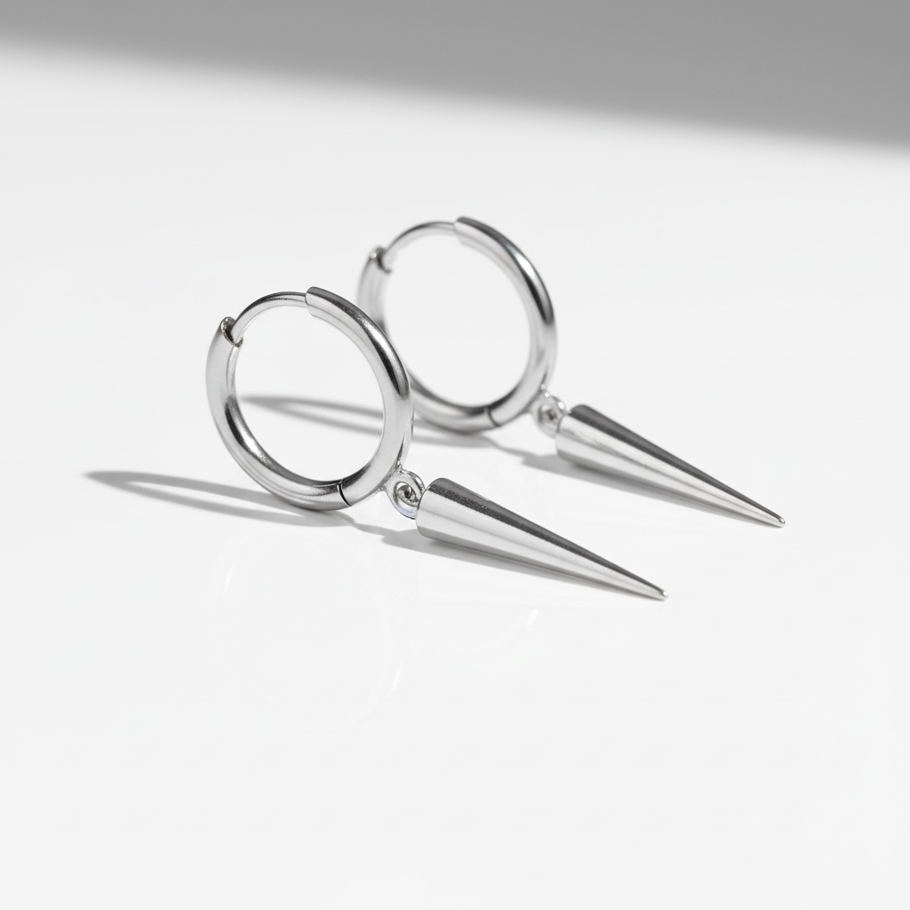 Minimalist silver hoop earrings with pointed spike dangles on a white background