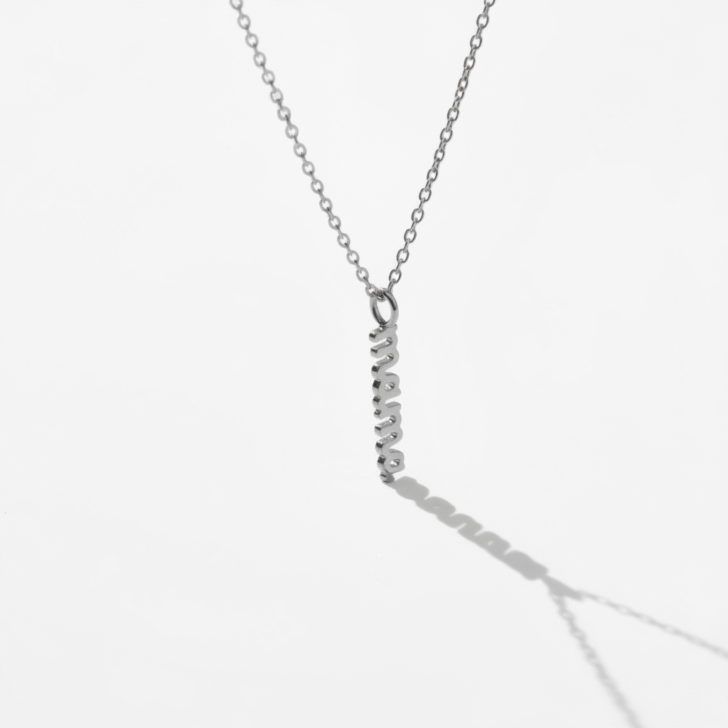 Minimalist silver necklace with vertical bar pendant on white background