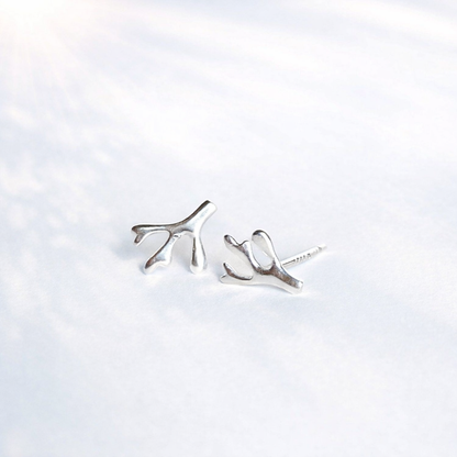 Minimalist silver branch stud earrings on a white background, handmade jewelry