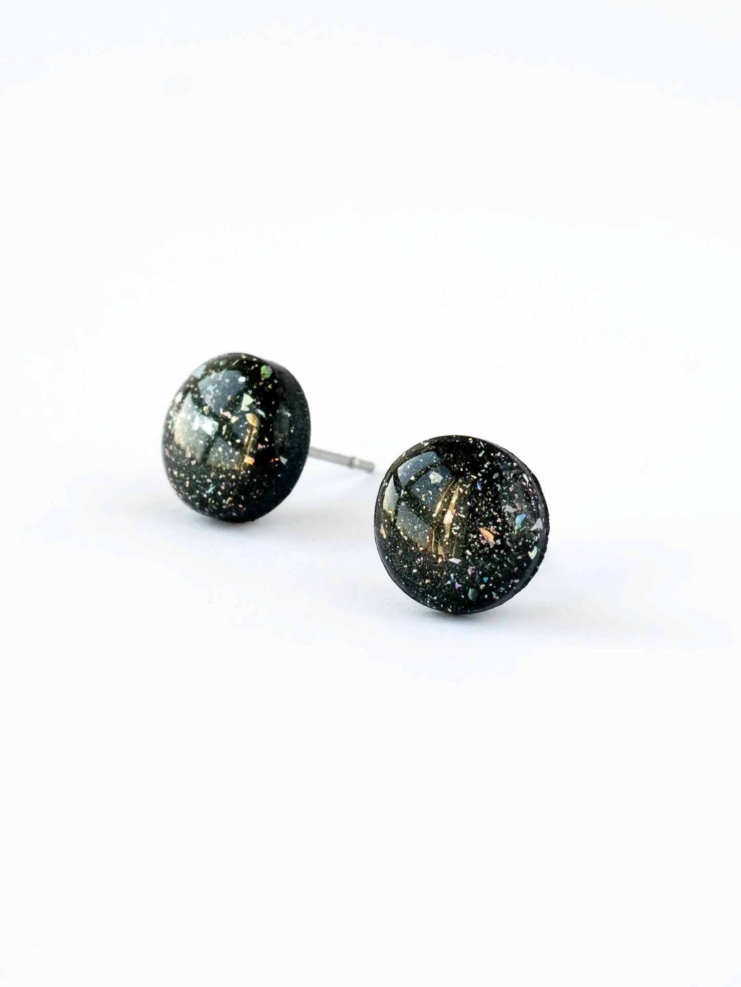 Pair of round stud earrings with a speckled design on a white background