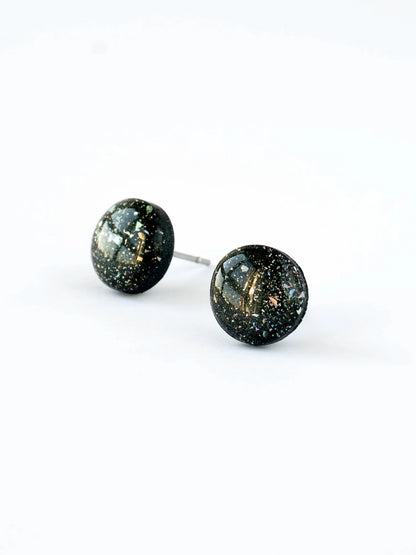 Pair of round stud earrings with a speckled design on a white background