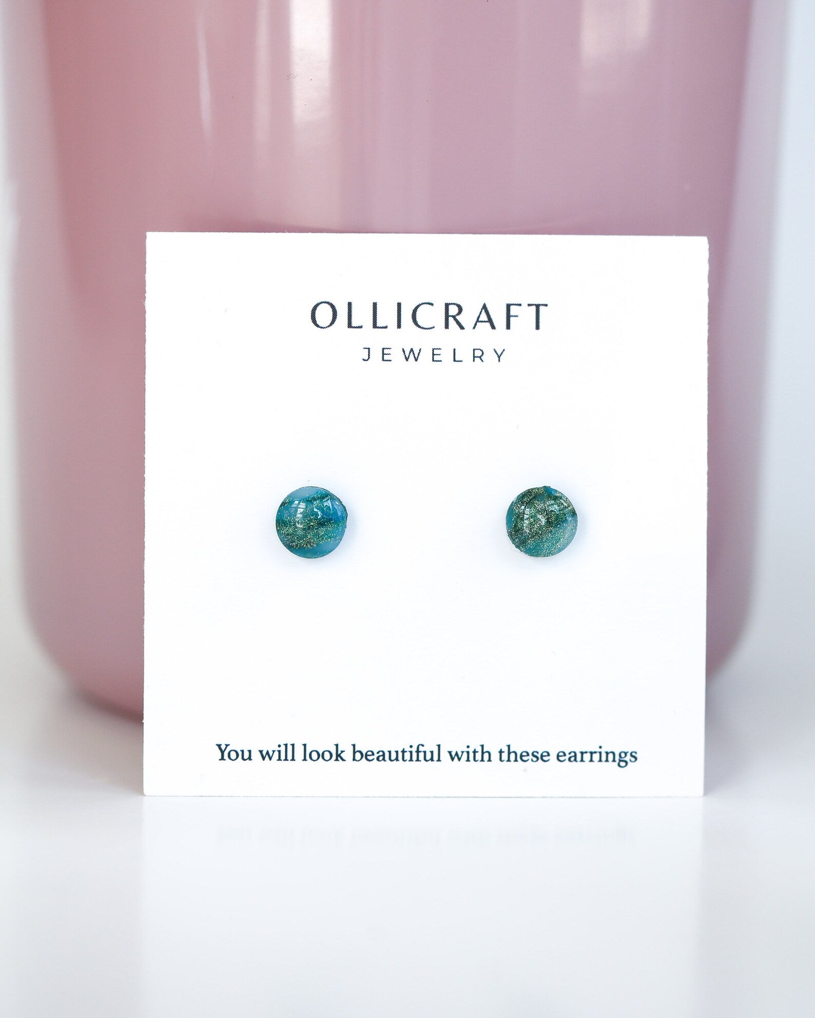 Oval earrings on Ollicraft jewelry card with pink background