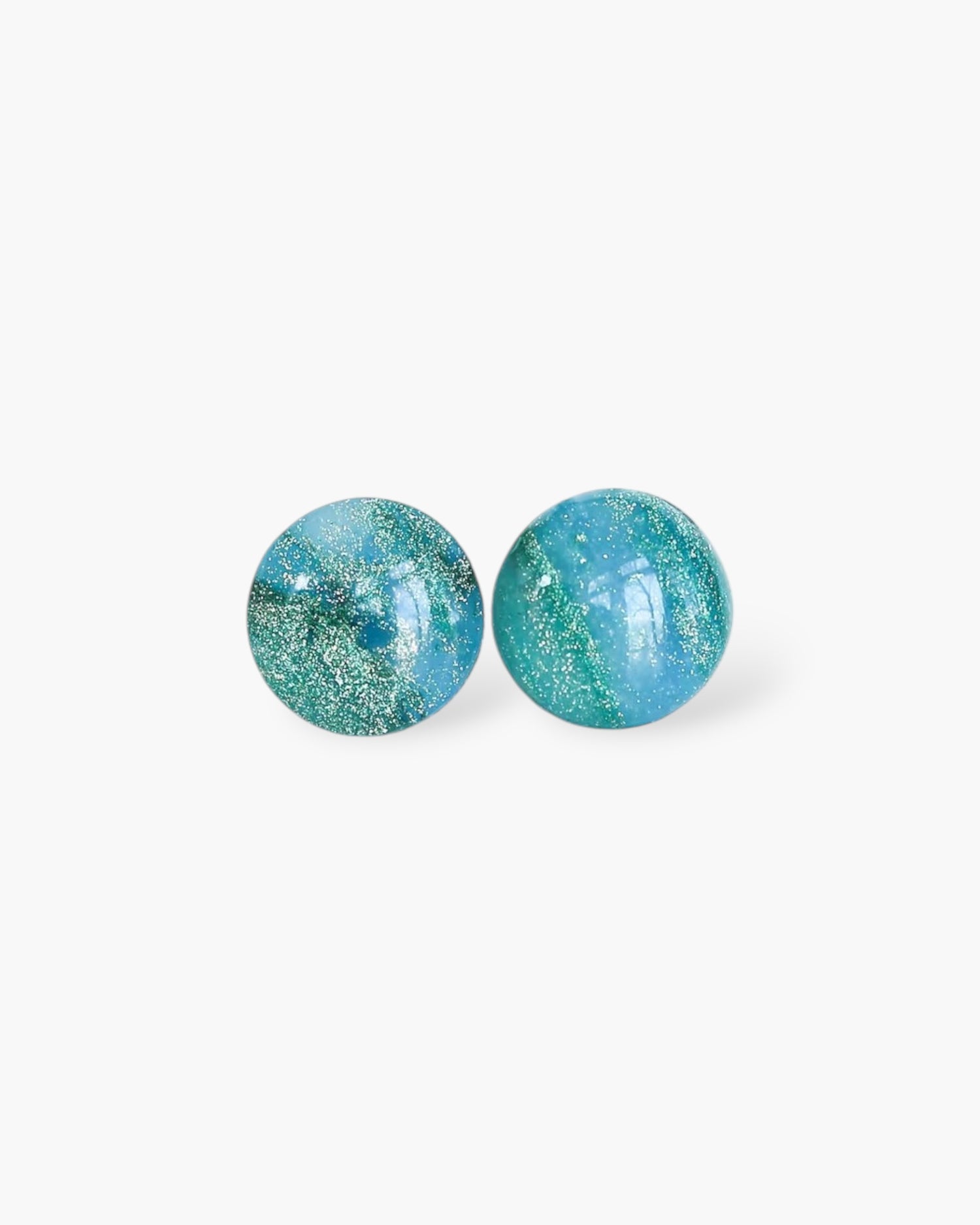 Pair of turquoise round earrings on a white background