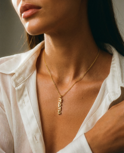 Woman wearing gold stainless steel 'mama' charm necklace with minimalist style
