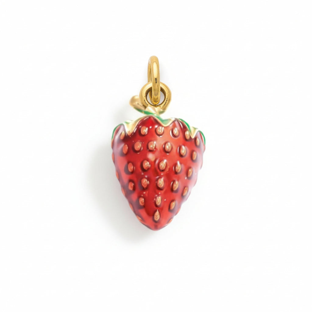 Handmade gold and enamel strawberry charm pendant with red berry design on white background
