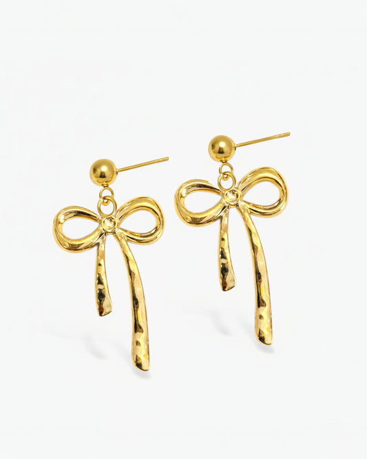 Gold bow-shaped earrings on a white background