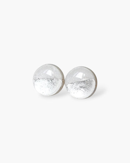 Pair of silver round earrings on a white background