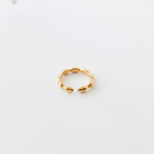 Ollijewelry minimalist gold ring with a polished beaded design and an open adjustable band on a white background.