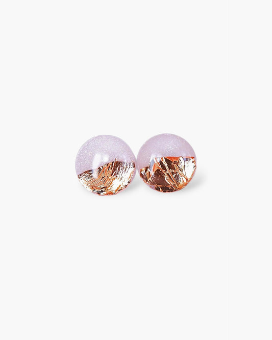 Pair of earrings with pink and gold finishes on a white background